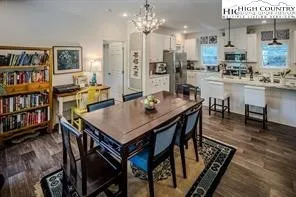 a view of a dining room with furniture and a book shelf