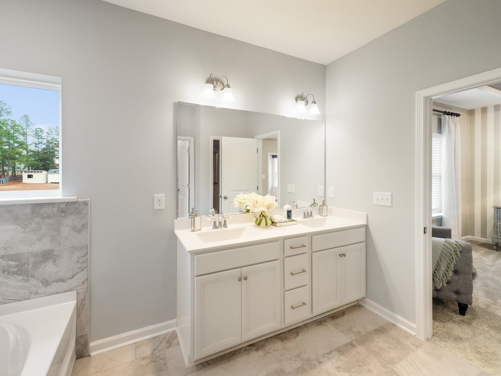 112 Keyshore Bend, Unit 163 Raleigh, NC 27610 - Photo 19 of 32 a spacious bathroom with a double vanity sink a mirror and a