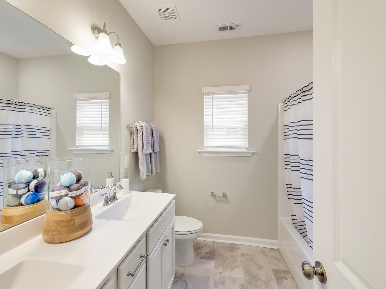 112 Keyshore Bend, Unit 163 Raleigh, NC 27610 - Photo 28 of 32 a bathroom with a sink a toilet and a mirror