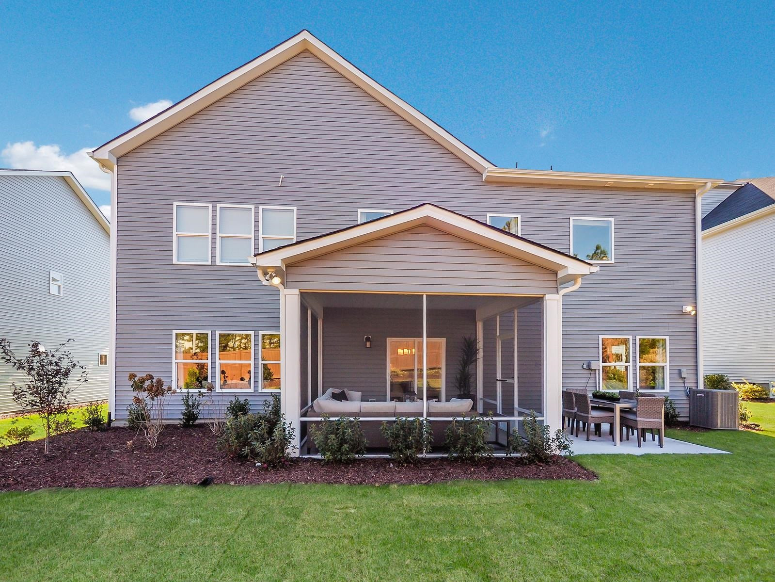 112 Keyshore Bend, Unit 163 Raleigh, NC 27610 - Photo 31 of 32 a front view of a house with a garden and plants