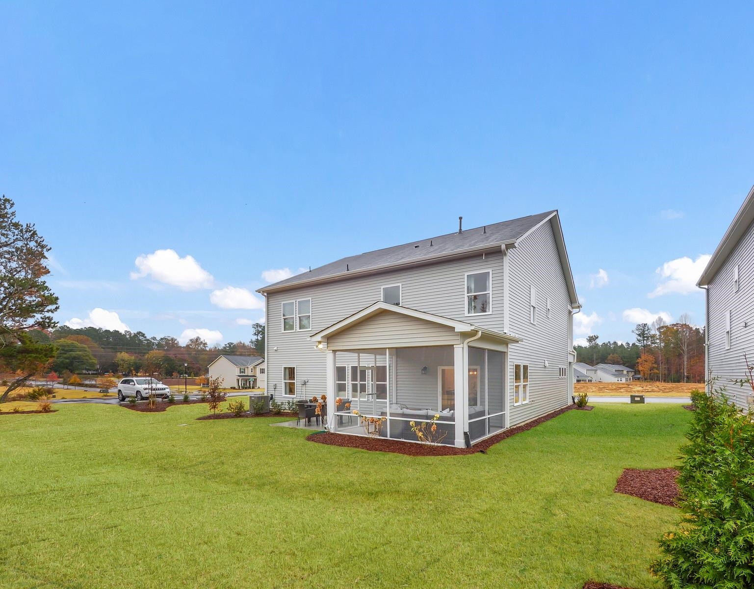112 Keyshore Bend, Unit 163 Raleigh, NC 27610 - Photo 32 of 32 a view of a house with a yard and sitting area