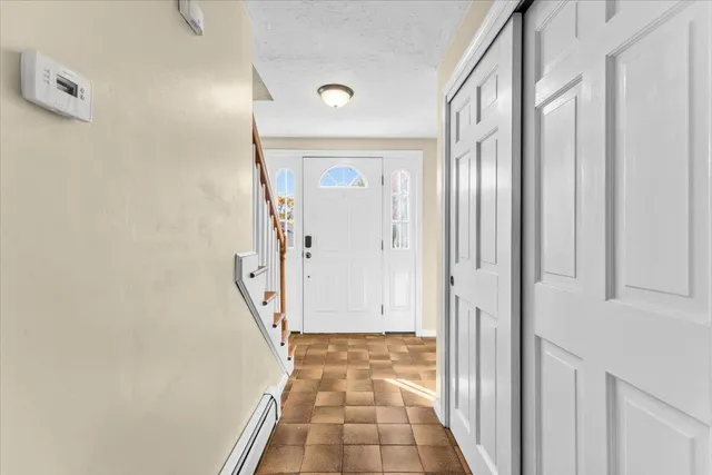 a kitchen with granite countertop white cabinets and stainless steel appliances