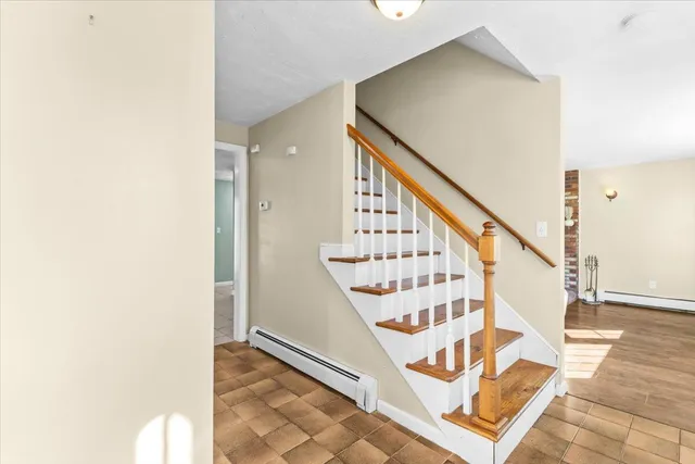 a kitchen with a refrigerator a stove top oven and white cabinets