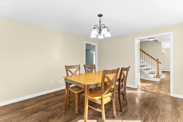 a kitchen with white cabinets and refrigerator