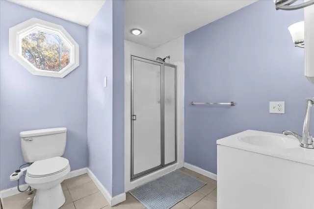 a bathroom with a granite countertop sink toilet and mirror