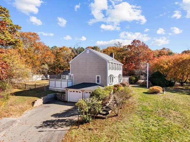 a view of a house with a yard covered in snow