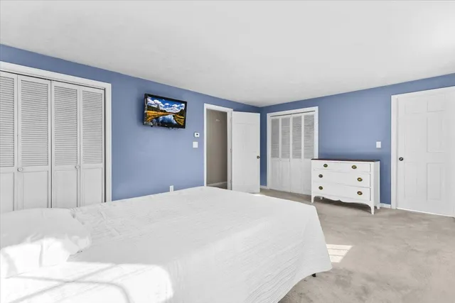 a view of livingroom with furniture large window and kitchen view