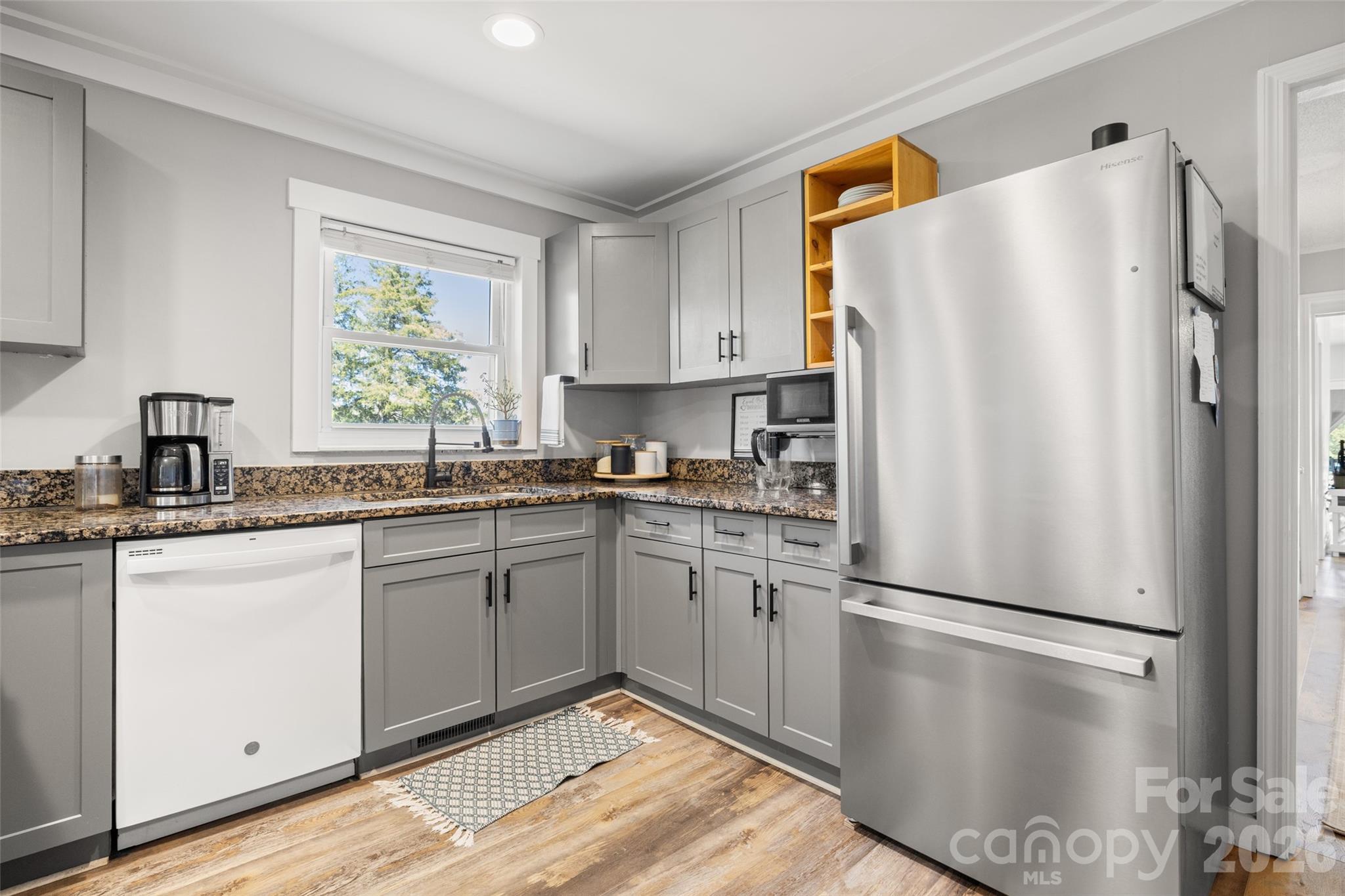 4790 Polk Ford Road Stanfield, NC 28163 - Photo 12 of 45 a kitchen with stainless steel appliances a refrigerator sink and microwave