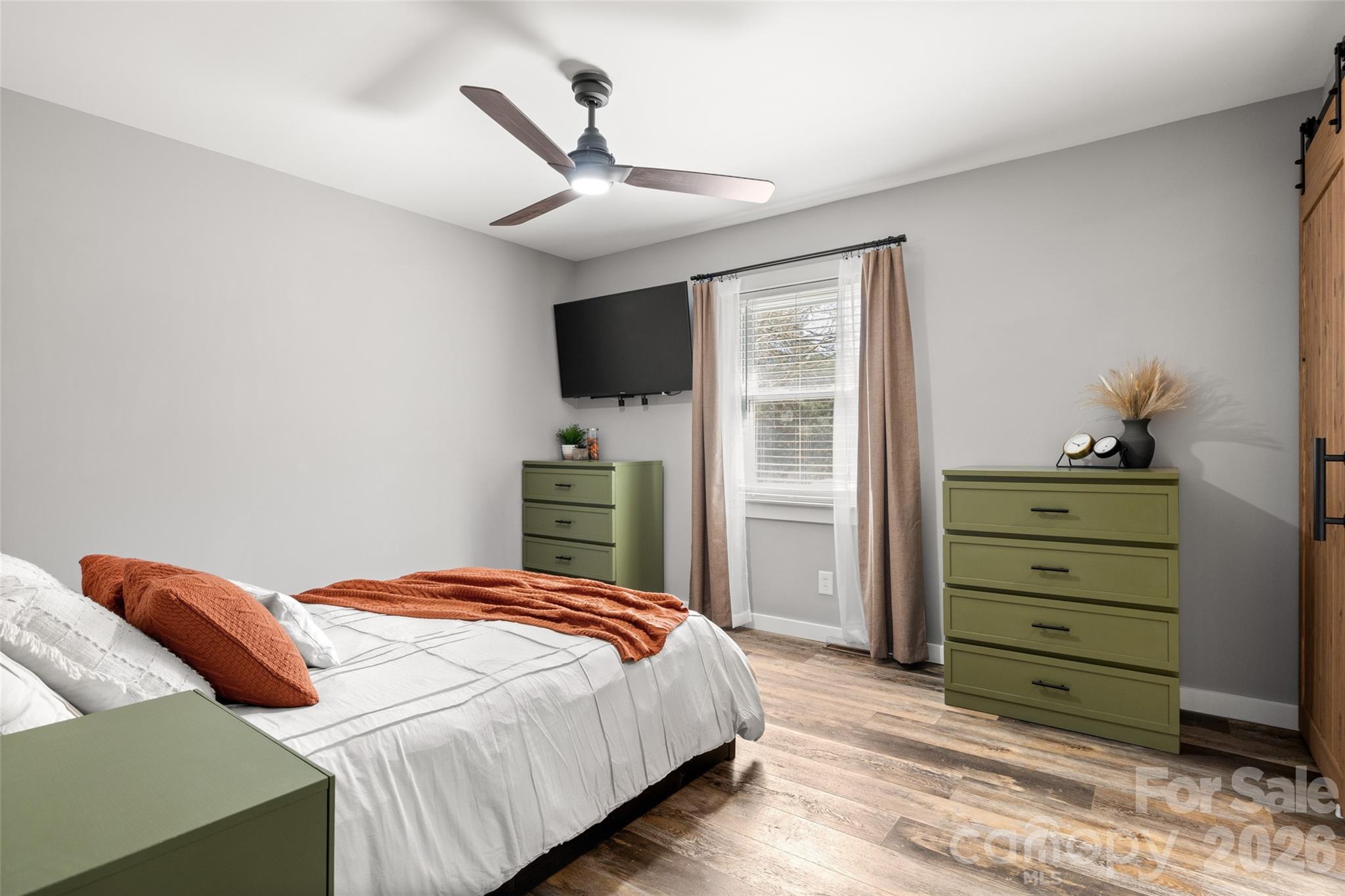 4790 Polk Ford Road Stanfield, NC 28163 - Photo 13 of 45 a bedroom with a bed and a flat screen tv