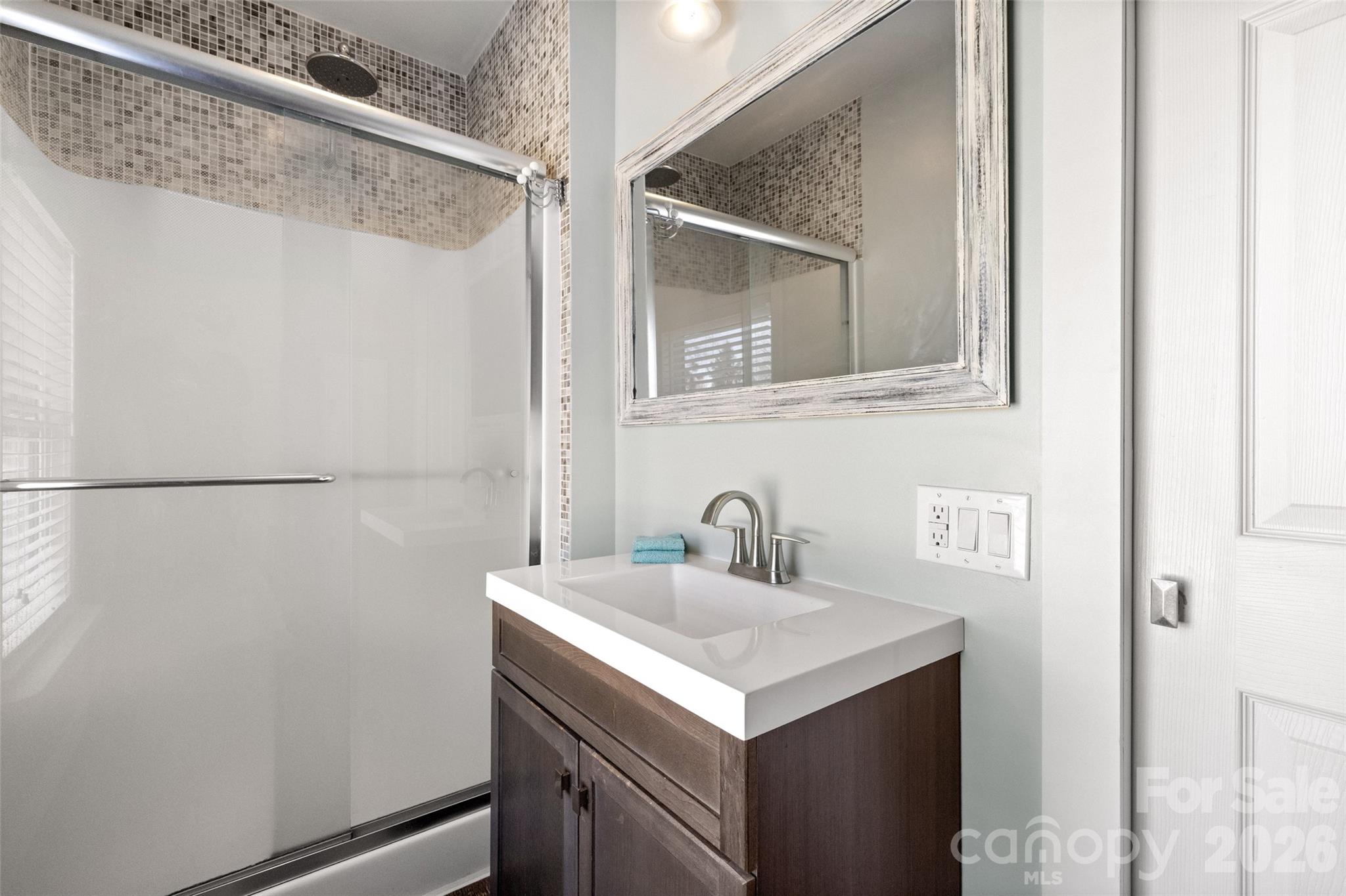 4790 Polk Ford Road Stanfield, NC 28163 - Photo 20 of 45 a bathroom with a sink and mirror