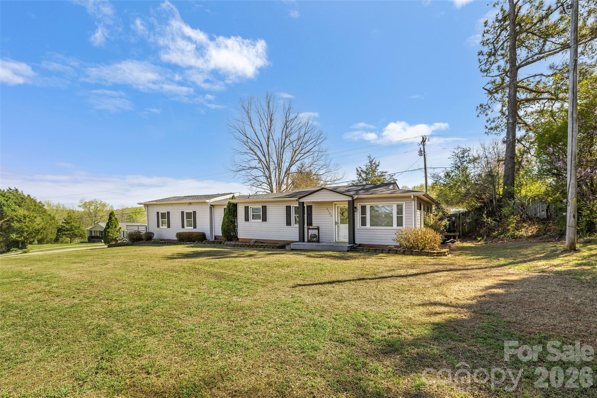 4790 Polk Ford Road Stanfield, NC 28163 - Photo 2 of 45 a view of a house next to a big yard with large trees