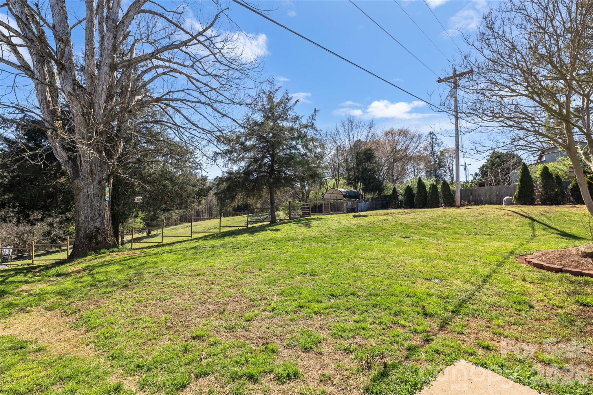 4790 Polk Ford Road Stanfield, NC 28163 - Photo 30 of 45 a backyard of a house with lots of green space