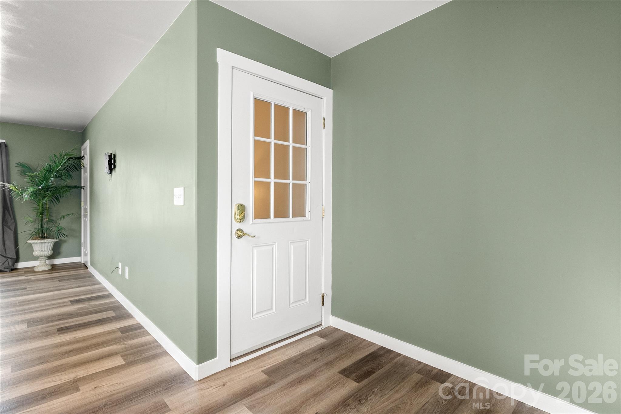 4790 Polk Ford Road Stanfield, NC 28163 - Photo 32 of 45 a view of a hallway with wooden floor and a bathroom