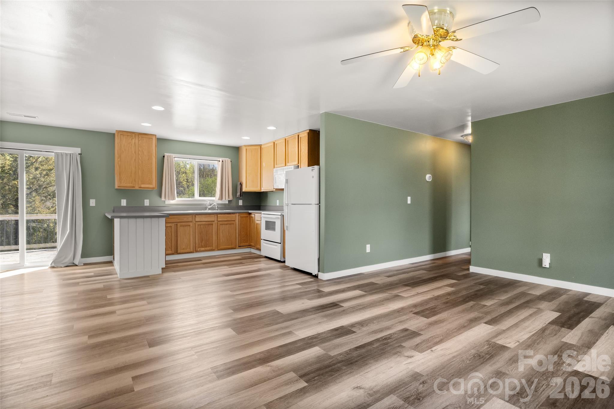 4790 Polk Ford Road Stanfield, NC 28163 - Photo 35 of 45 a view of a big room with wooden floor and a kitchen