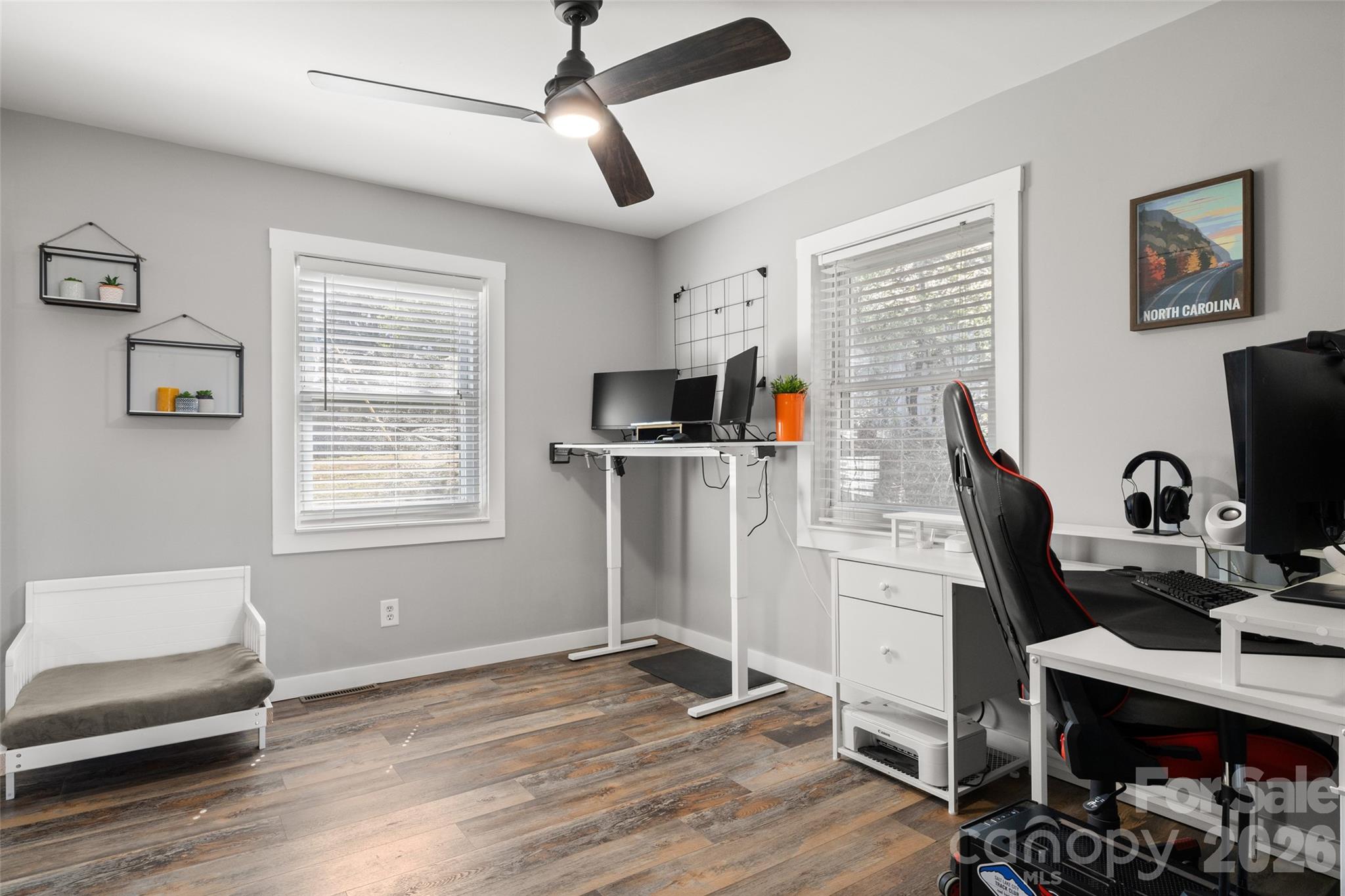 4790 Polk Ford Road Stanfield, NC 28163 - Photo 8 of 45 a view of workspace with wooden floor windows ceiling fan