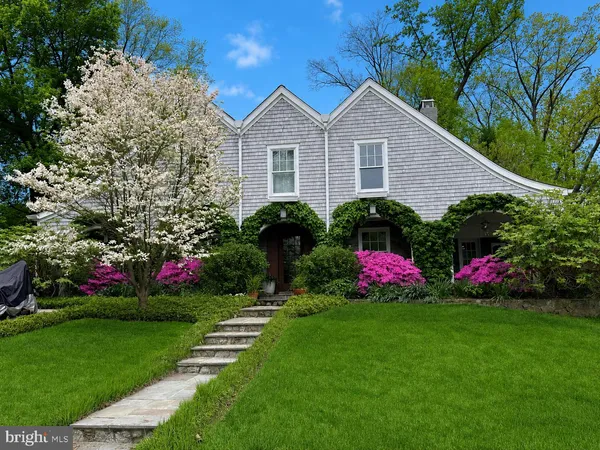 a front view of house with yard and flowers