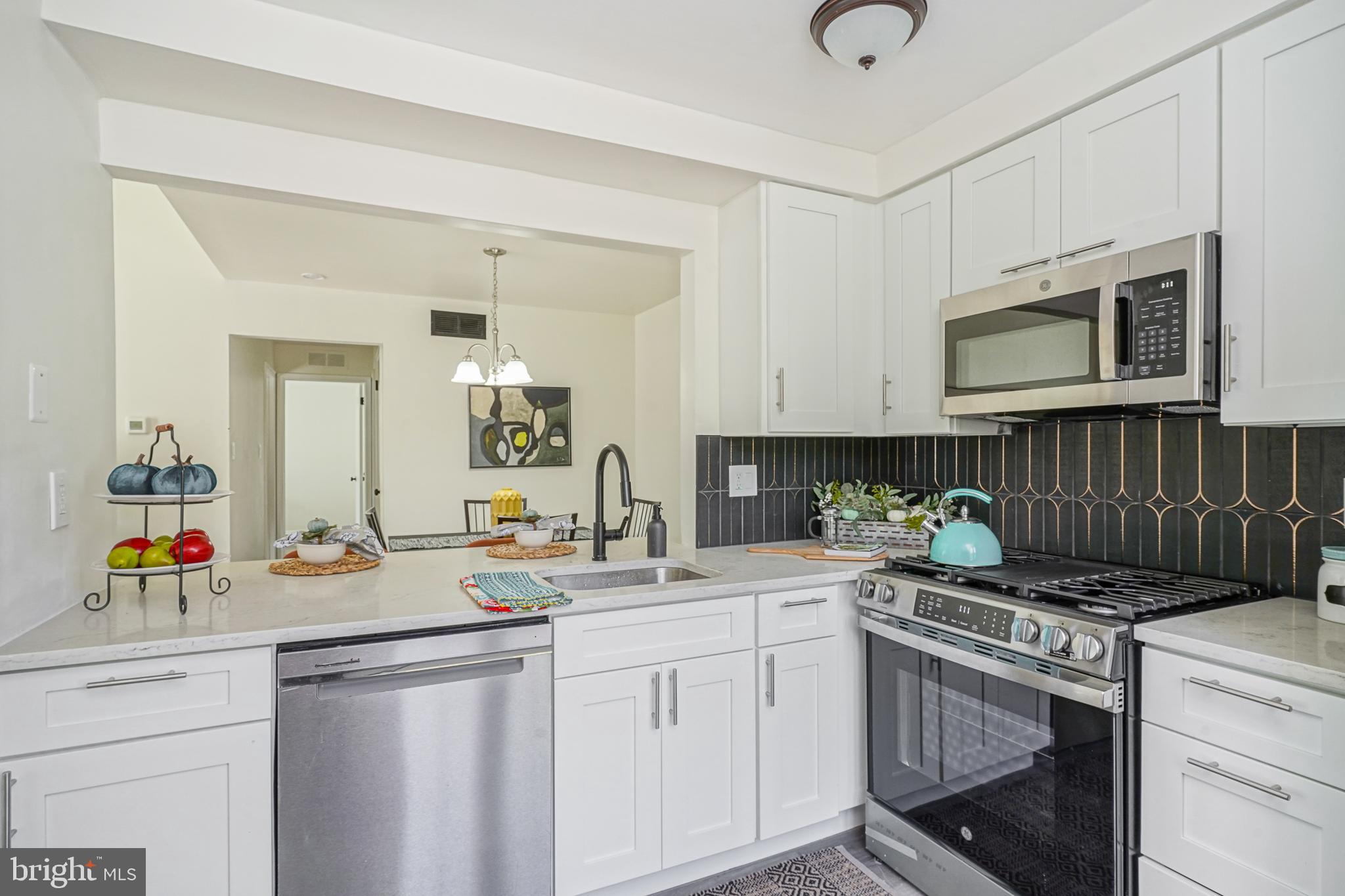 1104 B Ralston Drive Mount Laurel, NJ 08054 - Photo 9 of 24 a kitchen with a sink stove and cabinets
