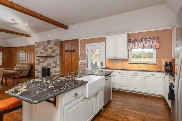 a kitchen with a stove a sink and a refrigerator