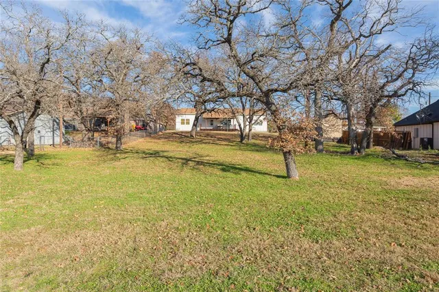 a view of a yard with swimming pool