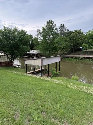 a view of a house with a yard and sitting area