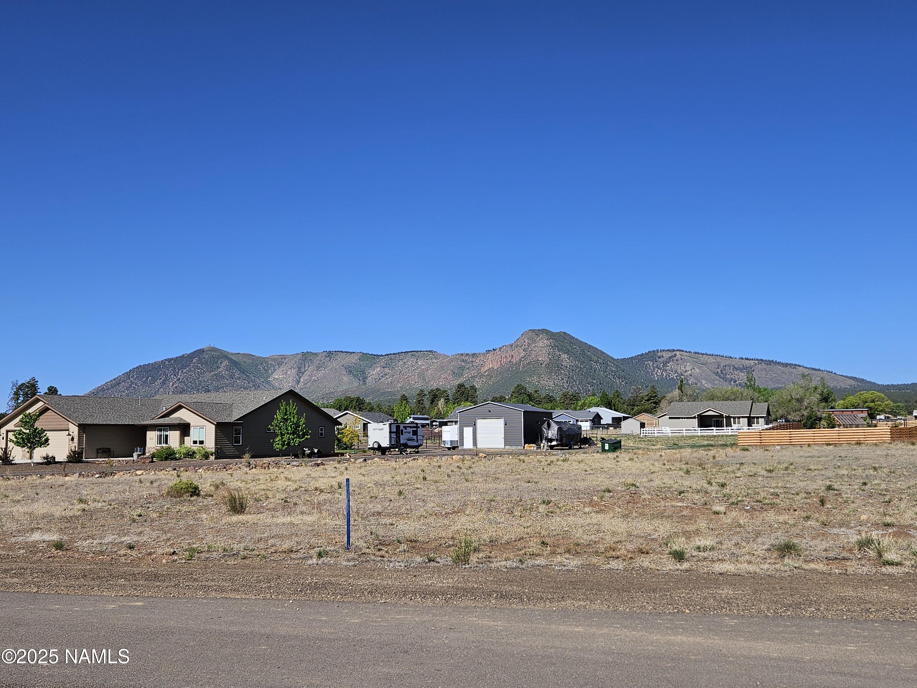 6668 Johnson Ranch Road Flagstaff, AZ 86004 - Photo 4 of 5 a view of large house with a road