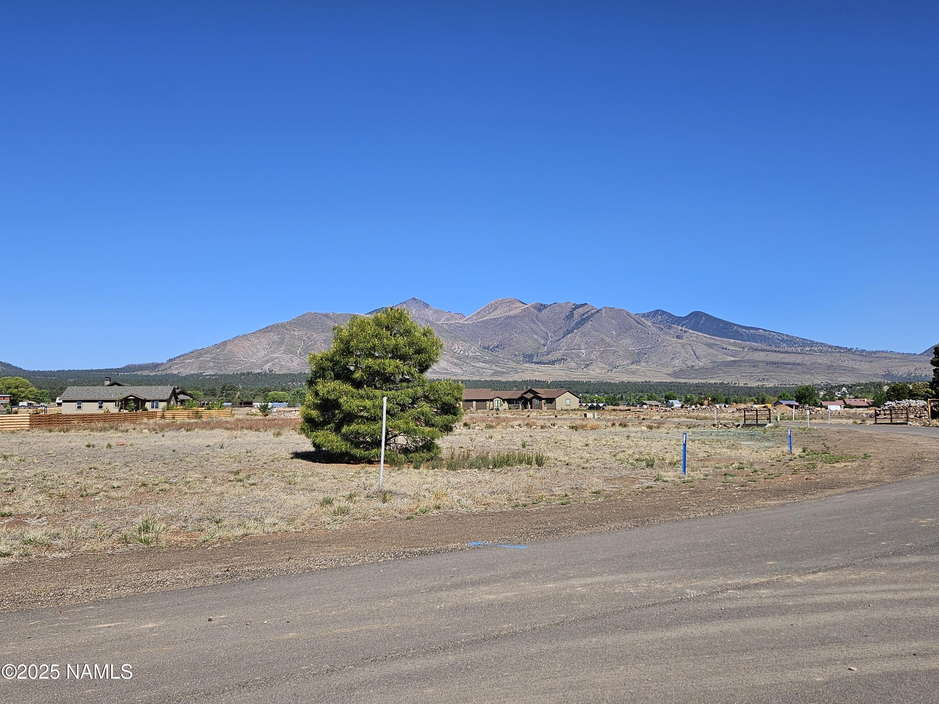 6668 Johnson Ranch Road Flagstaff, AZ 86004 - Photo 5 of 5 a view of a lake and a mountain