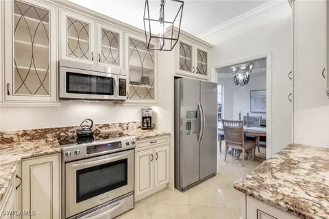 a kitchen with stainless steel appliances granite countertop a stove and a sink