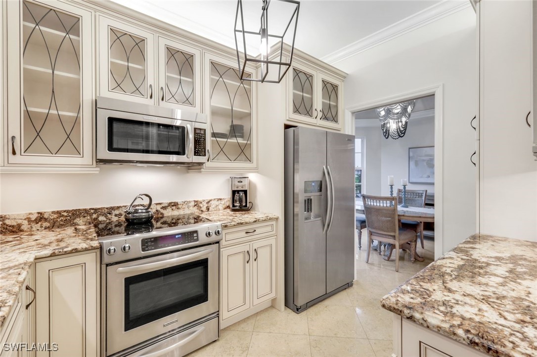 401 Bayfront Place, Unit 3301 Naples, FL 34102 - Photo 11 of 30 a kitchen with stainless steel appliances granite countertop a stove microwave and refrigerator