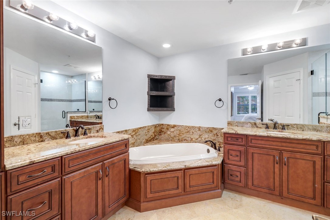 401 Bayfront Place, Unit 3301 Naples, FL 34102 - Photo 18 of 30 a bathroom with a granite countertop double vanity sink and mirror