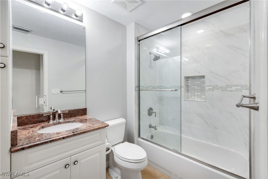 401 Bayfront Place, Unit 3301 Naples, FL 34102 - Photo 21 of 30 a bathroom with a granite countertop sink toilet and shower