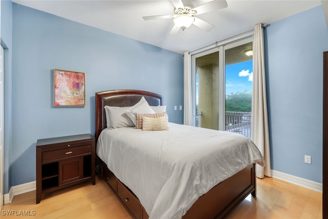 401 Bayfront Place, Unit 3301 Naples, FL 34102 - Photo 22 of 30 a bedroom with a bed and a chandelier