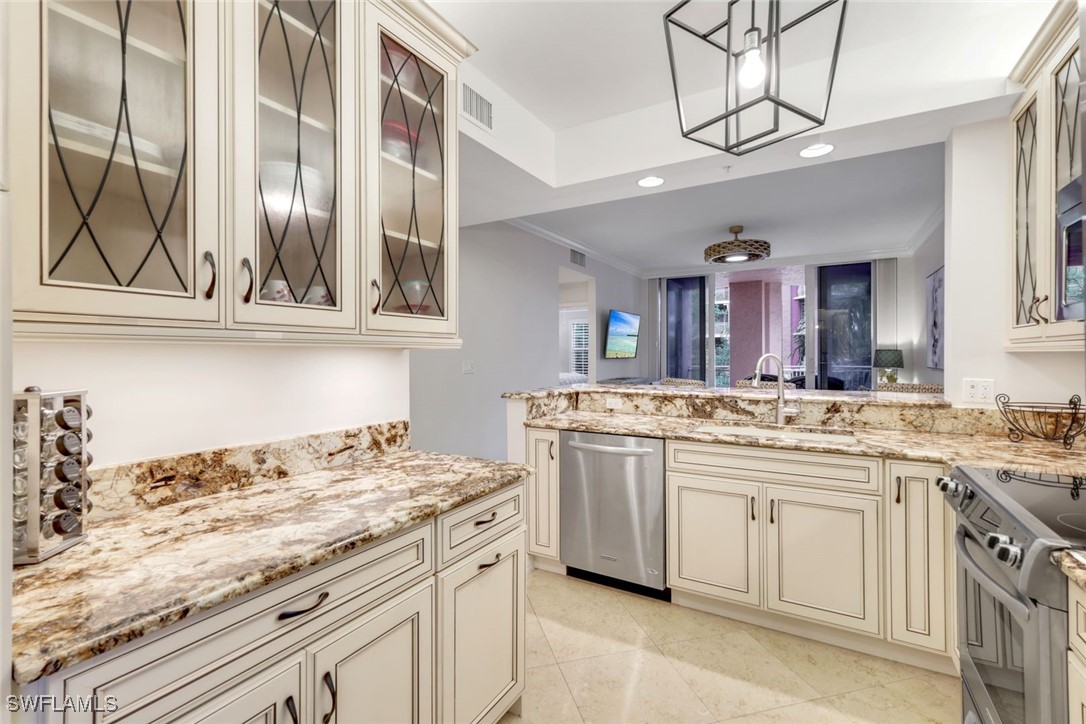 401 Bayfront Place, Unit 3301 Naples, FL 34102 - Photo 8 of 30 a kitchen with a sink stove and cabinets