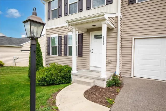 a view of a house with a small yard and a large window