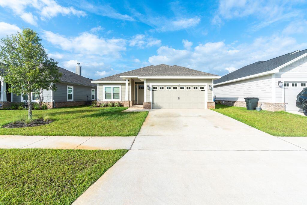 113 Cool Breeze Drive Freeport, FL 32439 - Photo 1 of 16 a front view of a house with a yard and garage