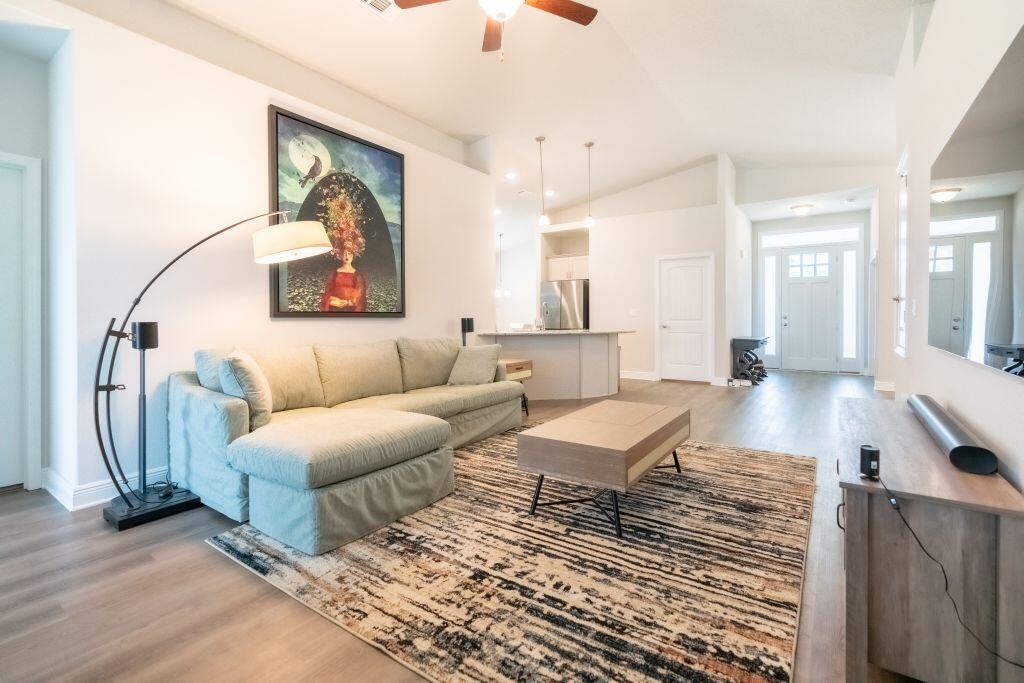 113 Cool Breeze Drive Freeport, FL 32439 - Photo 3 of 16 a living room with couches and a coffee table with wooden floor