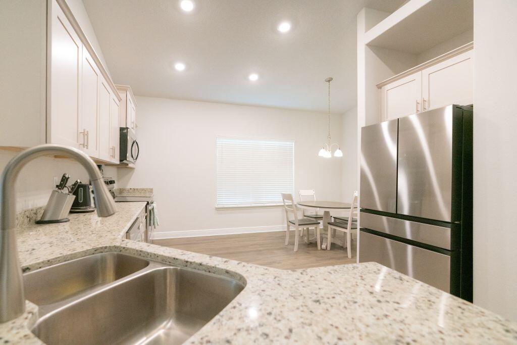 113 Cool Breeze Drive Freeport, FL 32439 - Photo 7 of 16 a kitchen with a refrigerator sink and wooden floor