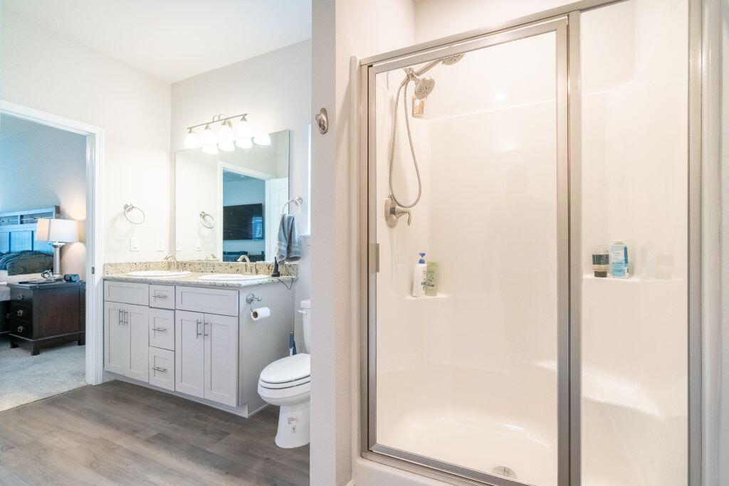 113 Cool Breeze Drive Freeport, FL 32439 - Photo 10 of 16 a bathroom with a granite countertop sink toilet a shower and a mirror