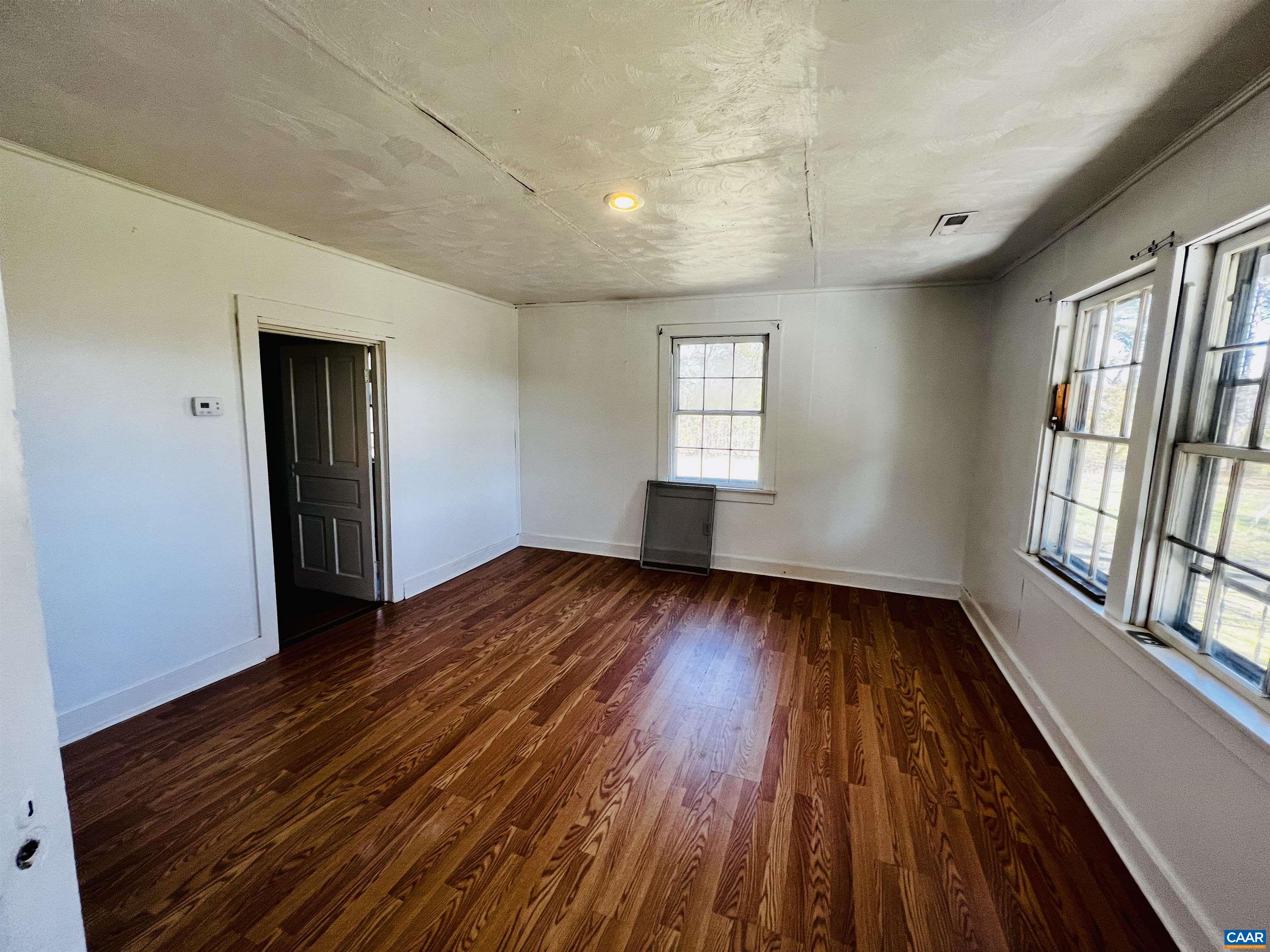 2753 Ridge Road Arvonia, VA 23004 - Photo 5 of 16 a view of an empty room with wooden floor and a window