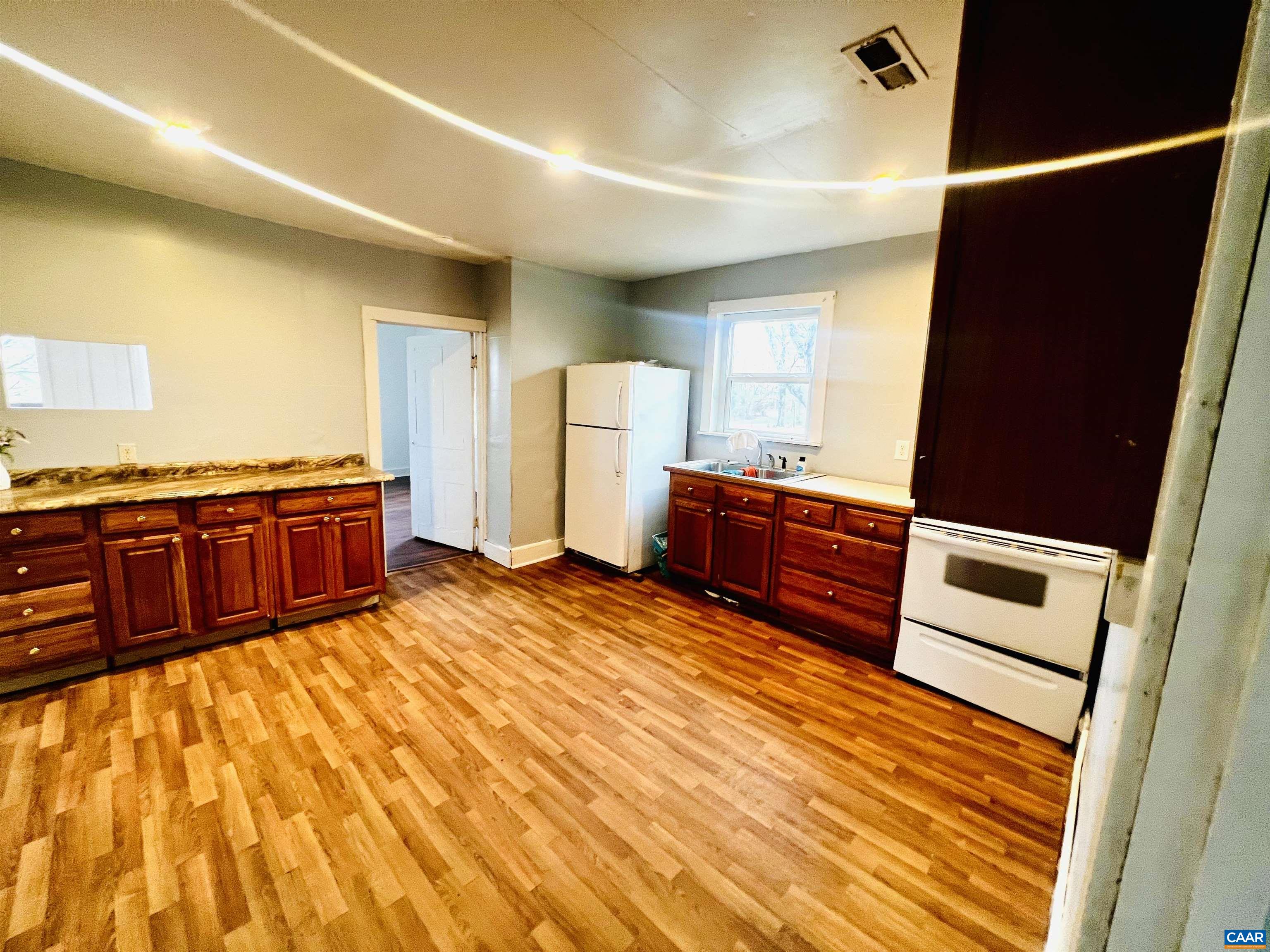 2753 Ridge Road Arvonia, VA 23004 - Photo 9 of 16 a kitchen with stainless steel appliances wooden cabinets a stove and a refrigerator
