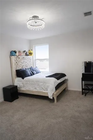 a bedroom with a bed and a chair