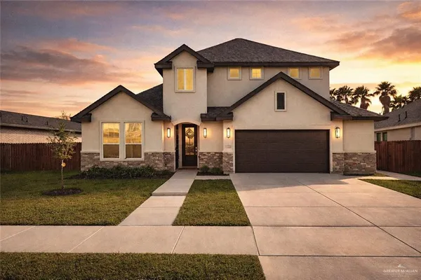 a front view of a house with a yard and garage