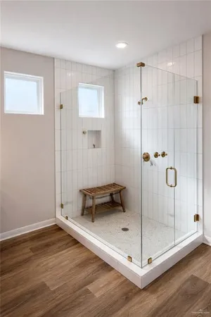 a bathroom with a glass shower door