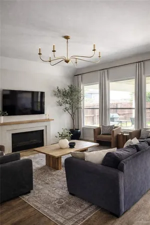 a living room with furniture fireplace and flat screen tv