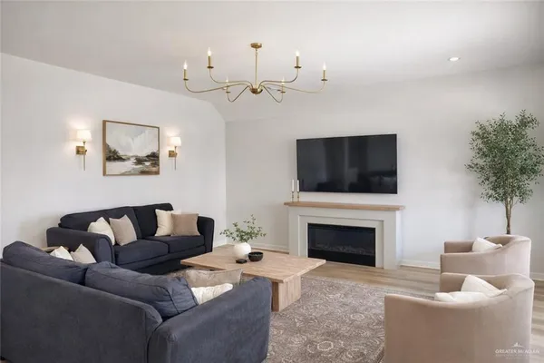 a living room with furniture a fireplace and a flat screen tv