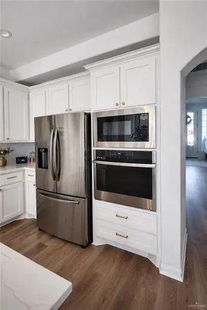 a kitchen with appliances a sink and a refrigerator