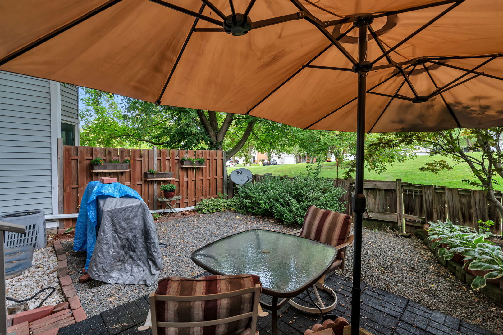 522 Julie Road Bolingbrook, IL 60440 - Photo 23 of 28 a backyard of a house with table and chairs under an umbrella