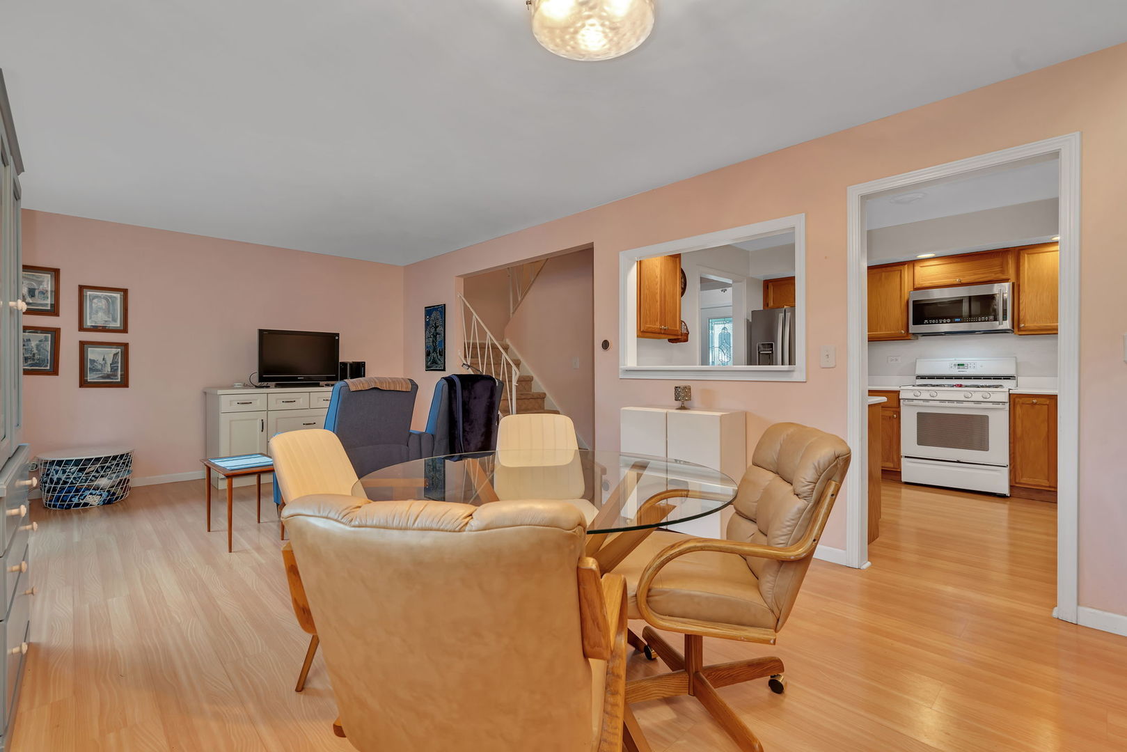 522 Julie Road Bolingbrook, IL 60440 - Photo 5 of 28 a living room with furniture a flat screen tv and kitchen view