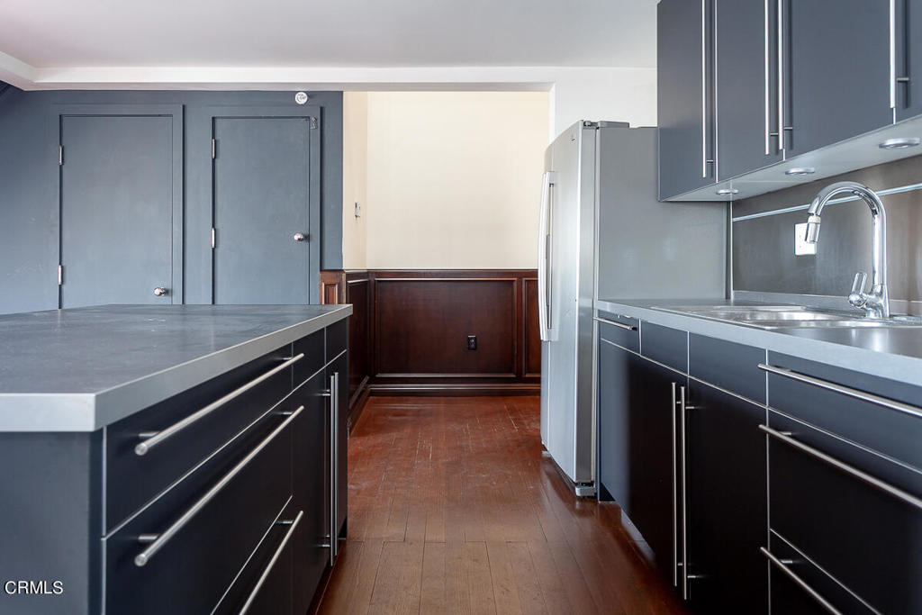 257 South Spring Street, Unit PHE Los Angeles, CA 90012 - Photo 8 of 32 a kitchen with stainless steel appliances granite countertop a refrigerator and a stove
