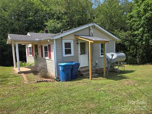 a front view of house with yard and outdoor seating