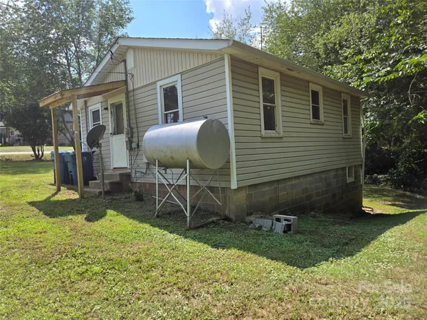a backyard of a house with table and chairs